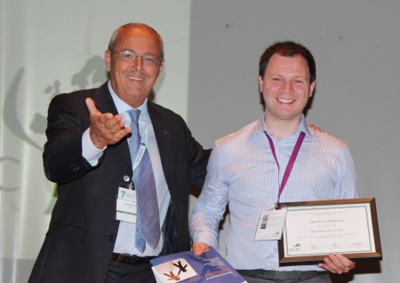 Dr Matthew Maddocks receives his award and prize from Professor Franco De Conno
